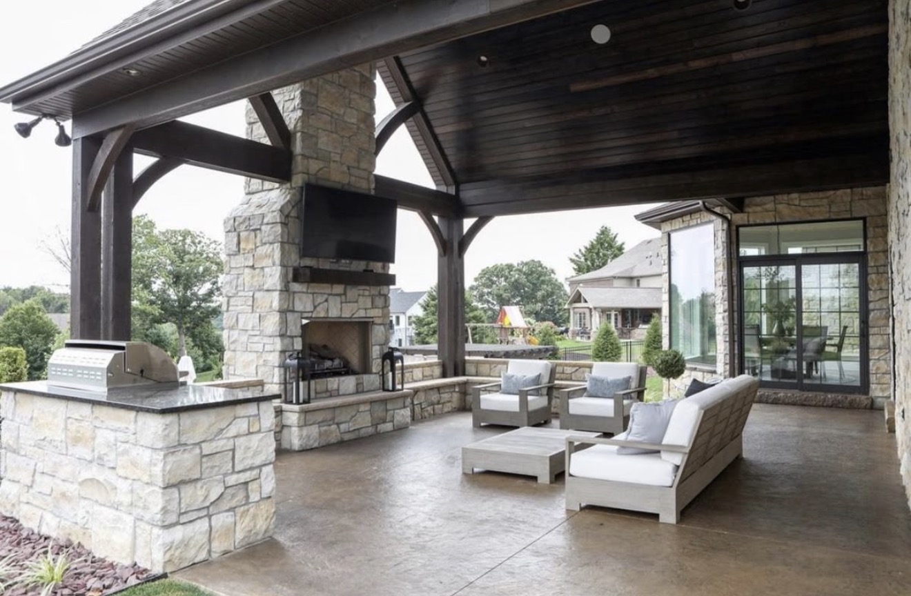 Covered pavilion with stone fireplace and outdoor kitchen